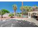 Lush backyard featuring mature palm trees, manicured landscaping, and a charming covered patio area at 4030 Del Monte Ave, Las Vegas, NV 89102