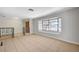 Bright living room boasts tile flooring, large window, and wrought iron railings, creating an inviting atmosphere at 4030 Del Monte Ave, Las Vegas, NV 89102