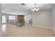 A bright living room space with decorative railings, tile flooring, neutral colors and a peek into the fireplace area at 4030 Del Monte Ave, Las Vegas, NV 89102