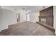 Spacious living room with a cozy brick fireplace, soft carpet and ample lighting at 4030 Del Monte Ave, Las Vegas, NV 89102