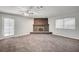 Comfortable living room with carpet flooring, a fireplace and a ceiling fan at 4030 Del Monte Ave, Las Vegas, NV 89102