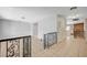 Open-concept living room featuring tile flooring, neutral walls, wrought iron railings, and a glimpse of the brick fireplace at 4030 Del Monte Ave, Las Vegas, NV 89102