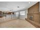 Spacious living room with tile floors, brick fireplace, and decorative wrought iron railings, perfect for gatherings at 4030 Del Monte Ave, Las Vegas, NV 89102