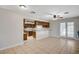 Open-concept living area with a ceiling fan, tile floors, and access to the kitchen at 4030 Del Monte Ave, Las Vegas, NV 89102