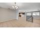 Bright, tiled living room and dining area showcasing an open floor plan and elegant chandelier at 4030 Del Monte Ave, Las Vegas, NV 89102