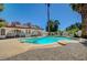 Backyard featuring a sparkling pool, mature palm trees, and a white house with a brown roof at 4030 Del Monte Ave, Las Vegas, NV 89102