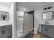 Renovated bathroom featuring stylish tile, grey cabinetry, and framed mirrors at 417 Freeman Ave, Las Vegas, NV 89106