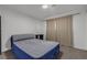 Bedroom featuring neutral carpet and an air mattress set on a frame with beige curtains at 417 Freeman Ave, Las Vegas, NV 89106