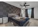 Bedroom featuring dark accent wall, modern fan, neutral carpet, and dark curtains at 417 Freeman Ave, Las Vegas, NV 89106