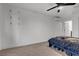 A minimalist bedroom featuring neutral carpet, a modern fan, and an air conditioning unit at 417 Freeman Ave, Las Vegas, NV 89106