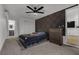 Bedroom with carpet, a dark colored accent wall and a dark wood dresser at 417 Freeman Ave, Las Vegas, NV 89106