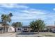 Charming single-story home with a well-maintained front yard and mature trees under a blue sky at 417 Freeman Ave, Las Vegas, NV 89106