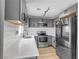 Well-lit kitchen features stainless steel appliances, grey cabinets, and bright white subway tile backsplash at 417 Freeman Ave, Las Vegas, NV 89106