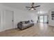 Bright living room with modern ceiling fan, hardwood floors, and a comfortable gray sofa at 417 Freeman Ave, Las Vegas, NV 89106