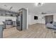 Open-concept living room and kitchen with stainless steel appliances and hardwood floors at 417 Freeman Ave, Las Vegas, NV 89106