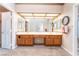 Well-lit bathroom vanity featuring a large mirror, dual sinks, and ample counter space at 4378 Cherrystone Ct, Las Vegas, NV 89121