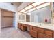 Bathroom vanity with dual sinks, a large mirror, and adjacent walk-in closet at 4378 Cherrystone Ct, Las Vegas, NV 89121