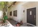 Inviting front entrance with a dark door, a side garden area, and decorative touches at 4378 Cherrystone Ct, Las Vegas, NV 89121