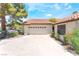 Attached two-car garage and spacious driveway with a well manicured yard in front at 4378 Cherrystone Ct, Las Vegas, NV 89121