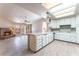 Bright kitchen with white cabinetry, a tile island, and views into the adjacent living area at 4378 Cherrystone Ct, Las Vegas, NV 89121