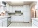 Well-lit kitchen with stainless steel dishwasher, tiled backsplash, and white cabinets at 4378 Cherrystone Ct, Las Vegas, NV 89121