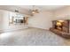 Open concept living room with a breakfast bar connected to the kitchen and a classic brick fireplace at 4378 Cherrystone Ct, Las Vegas, NV 89121