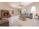 Inviting living room with a brick fireplace, neutral colors, and a ceiling fan for added comfort at 4378 Cherrystone Ct, Las Vegas, NV 89121
