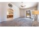 Spacious carpeted main bedroom with ceiling fan, backyard access, and adjacent bathroom vanity at 4378 Cherrystone Ct, Las Vegas, NV 89121