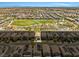 An aerial view highlights a park with green spaces, recreational facilities, and surrounding residences at 4511 Stardusk Falls Ave, North Las Vegas, NV 89084