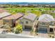 Aerial view of a two-story house showing backyard, neighborhood, community park and mountain views at 4511 Stardusk Falls Ave, North Las Vegas, NV 89084
