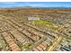 An aerial shot presents a well-planned community layout with houses, streets, and a central park area at 4511 Stardusk Falls Ave, North Las Vegas, NV 89084