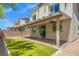 Inviting backyard features a covered patio, lush artificial turf, and a brick perimeter at 4511 Stardusk Falls Ave, North Las Vegas, NV 89084