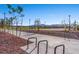 Community basketball court on a sunny day surrounded by native vegetation and bike rack at 4511 Stardusk Falls Ave, North Las Vegas, NV 89084
