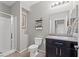 Bathroom featuring a shower, toilet, vanity, and medicine cabinet at 4511 Stardusk Falls Ave, North Las Vegas, NV 89084