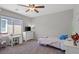 Cozy bedroom with a desk, twin bed, and ample natural light from a large window at 4511 Stardusk Falls Ave, North Las Vegas, NV 89084