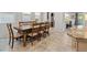 Spacious dining area featuring tile flooring, a large wooden table, and modern decor at 4511 Stardusk Falls Ave, North Las Vegas, NV 89084