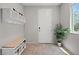 Well-organized entryway with coat hooks, bench seating, and shoe storage for added convenience at 4511 Stardusk Falls Ave, North Las Vegas, NV 89084