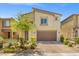 Inviting two-story home featuring drought-tolerant landscaping, two-car garage, and desert charm at 4511 Stardusk Falls Ave, North Las Vegas, NV 89084