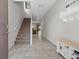 Welcoming foyer with neutral tile flooring, staircase, and convenient shoe storage at 4511 Stardusk Falls Ave, North Las Vegas, NV 89084