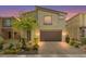 Two-story home with a landscaped front yard, brick driveway, and attached two-car garage at 4511 Stardusk Falls Ave, North Las Vegas, NV 89084