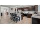 Kitchen featuring dark cabinetry, granite countertops, stainless steel appliances, and a breakfast bar at 4511 Stardusk Falls Ave, North Las Vegas, NV 89084