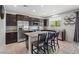 Bright kitchen featuring dark cabinetry, granite countertops, stainless steel appliances, and a center island at 4511 Stardusk Falls Ave, North Las Vegas, NV 89084
