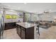 Open concept with island, granite countertops, stainless steel appliances and adjacent living room at 4511 Stardusk Falls Ave, North Las Vegas, NV 89084