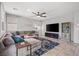 Bright living room with comfortable seating, modern decor, tile flooring and ceiling fan at 4511 Stardusk Falls Ave, North Las Vegas, NV 89084