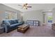 Cozy living room with comfortable blue couch, area rug, and lots of storage at 4511 Stardusk Falls Ave, North Las Vegas, NV 89084