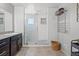 Bright main bathroom with glass enclosed shower and towel rack at 4511 Stardusk Falls Ave, North Las Vegas, NV 89084
