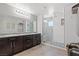 Bright main bathroom with double sinks, a glass enclosed shower, and modern fixtures at 4511 Stardusk Falls Ave, North Las Vegas, NV 89084