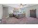 Spacious main bedroom with a large bed, side tables, neutral tones, and ceiling fan at 4511 Stardusk Falls Ave, North Las Vegas, NV 89084