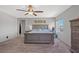 Spacious main bedroom with a large bed, side tables, neutral tones, and ceiling fan at 4511 Stardusk Falls Ave, North Las Vegas, NV 89084
