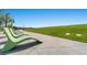 A tranquil park setting with modern seating arrangements overlooks a grassy area and distant mountain views at 4511 Stardusk Falls Ave, North Las Vegas, NV 89084